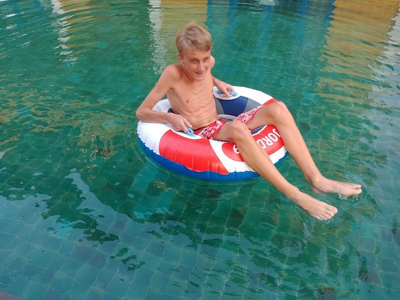 Teenage boy swimming in a pool