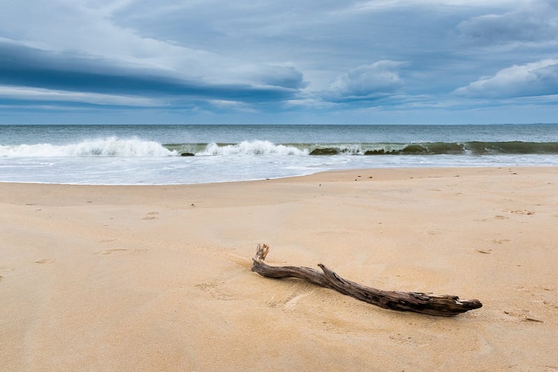 Tranquil beach scene with waves and sand patterns