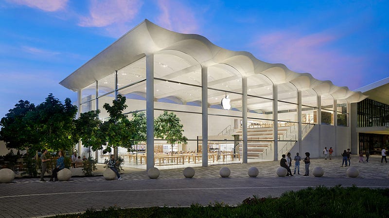 Apple retail store employees engaged in a meeting