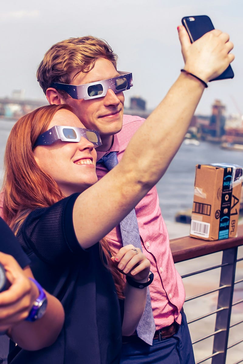 People enjoying a solar eclipse with protective glasses