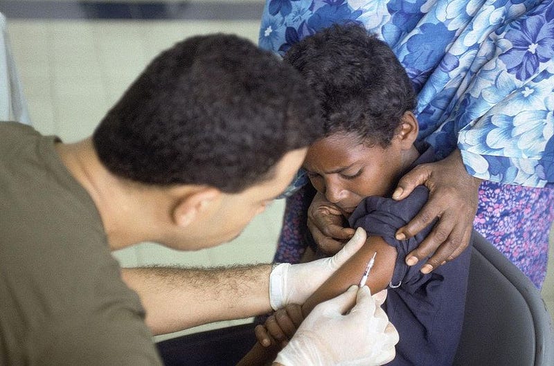 A child receiving a polio vaccination, highlighting vaccine importance.